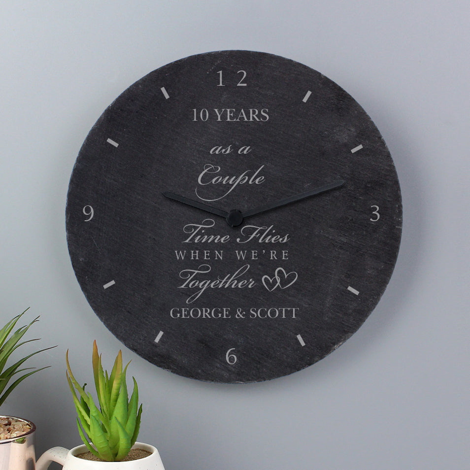 Decorative wall clock with personalised text on a grey background