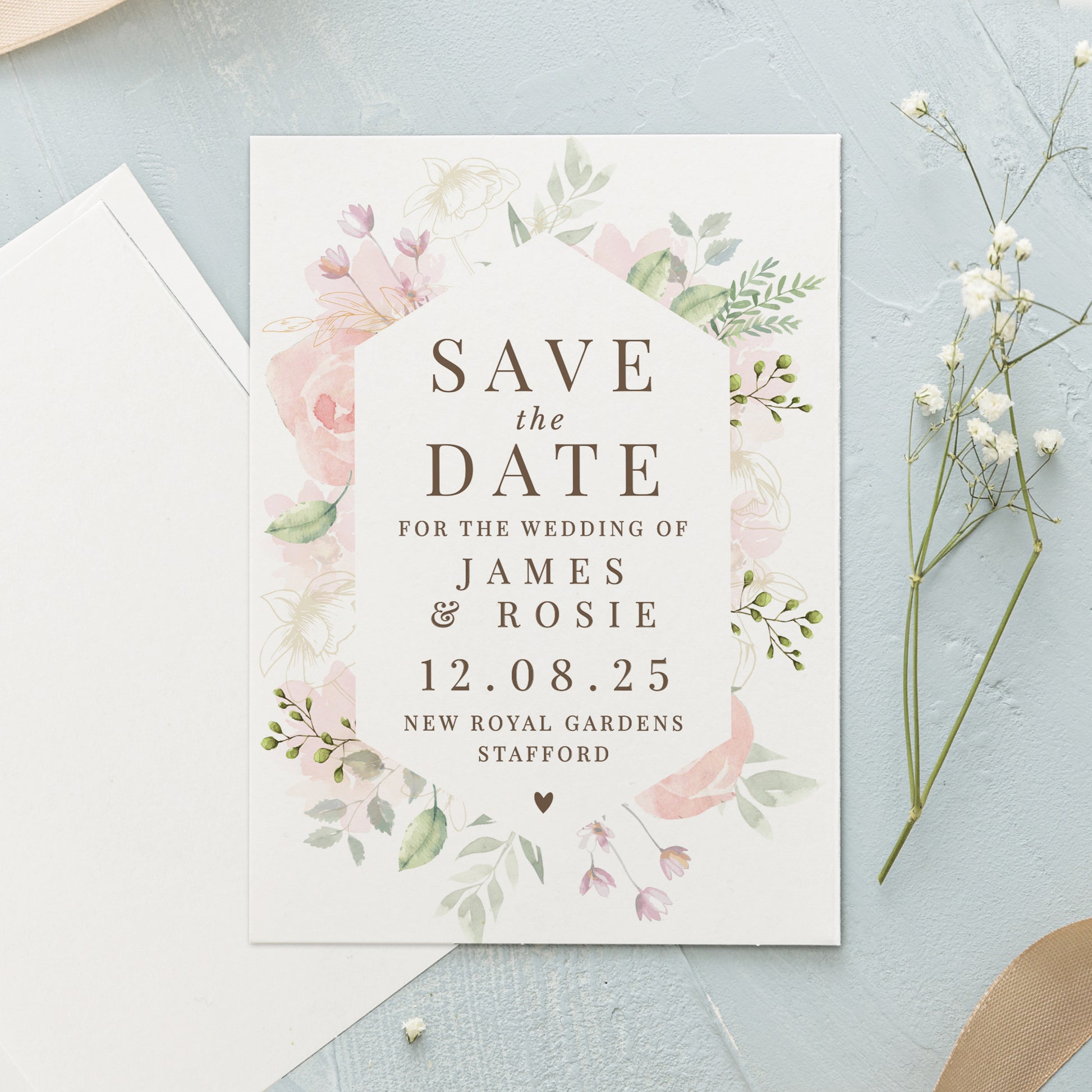 Wedding save the date card with floral design on a light blue background