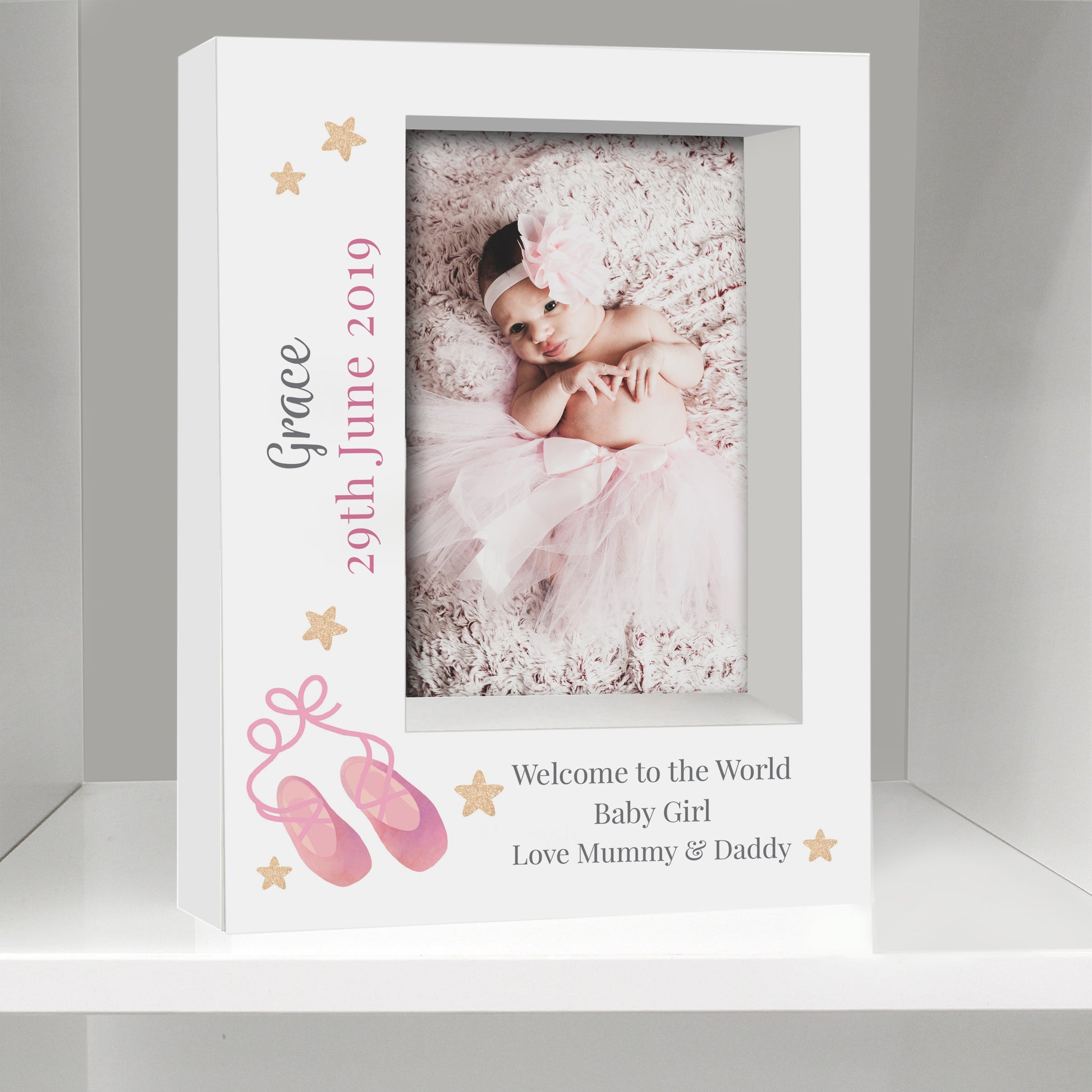 White photo frame with a baby girl's photo and personalized text on a gray background