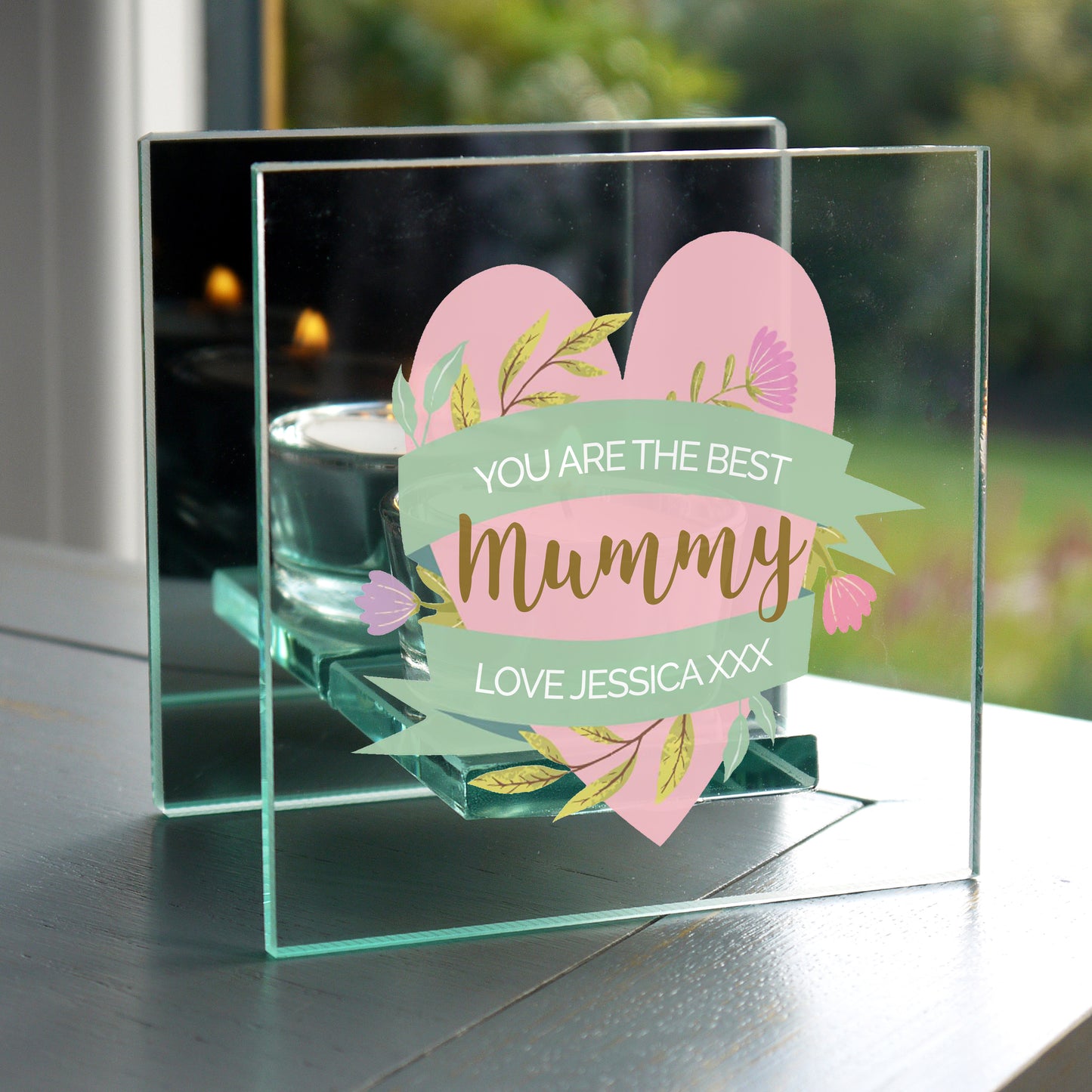 Personalised Clear Glass Tealight Holder showing message - You Are The Best Mummy Love Jessica. With pink heart, green scrolls and gold and white text.