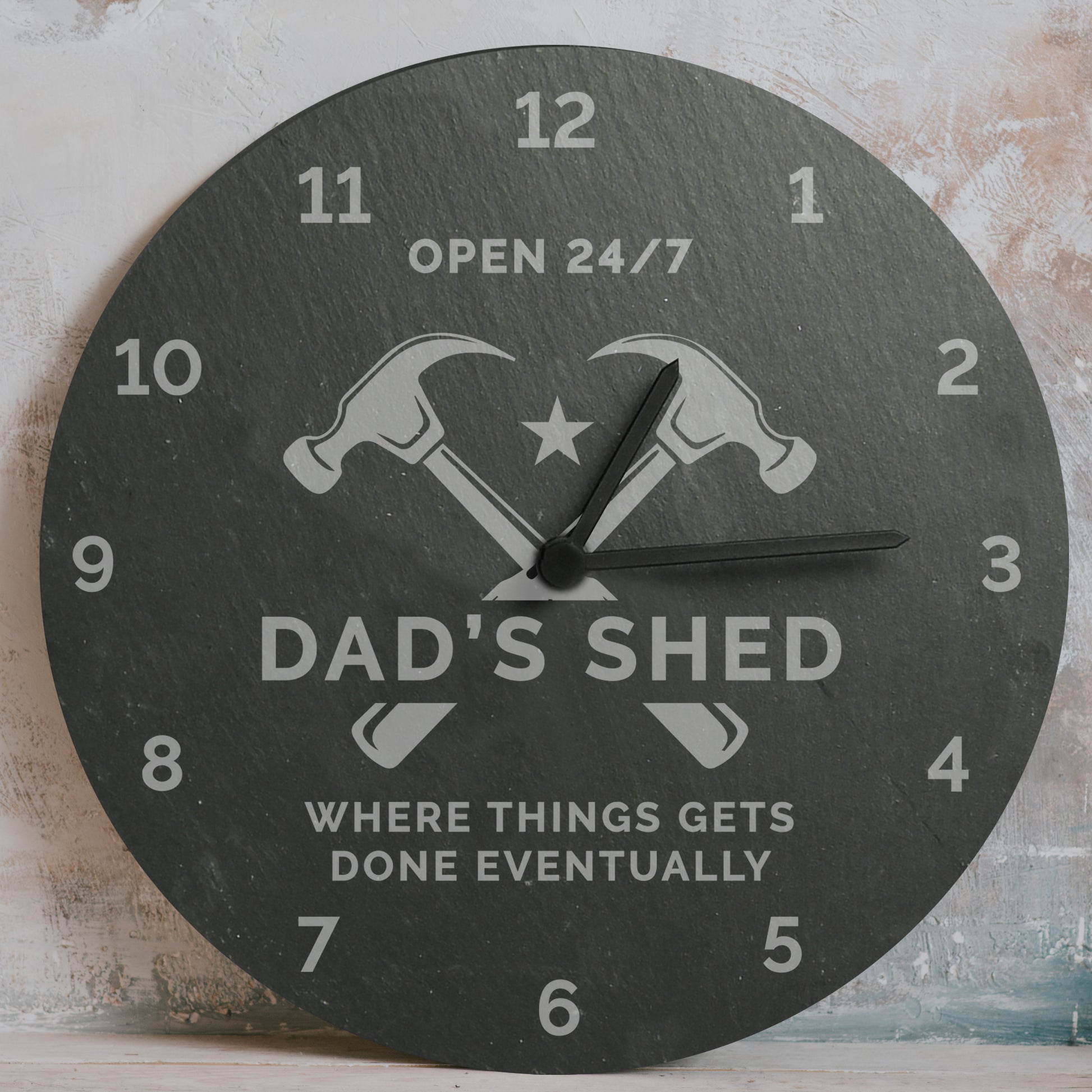 Round clock with 'Dad's Shed' design on a textured wall background
