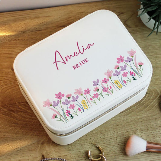 White jewelry case with floral design and 'Amelia Bride' text on a wooden surface.