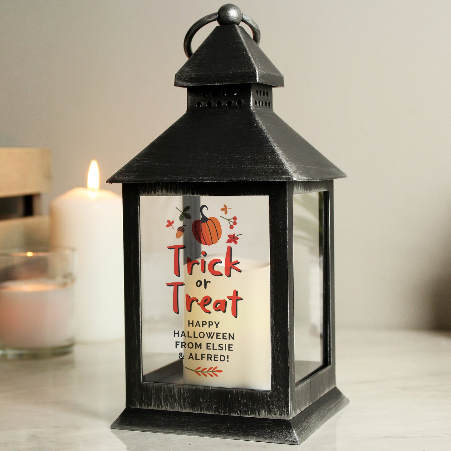 Black lantern with Halloween-themed message on a neutral background