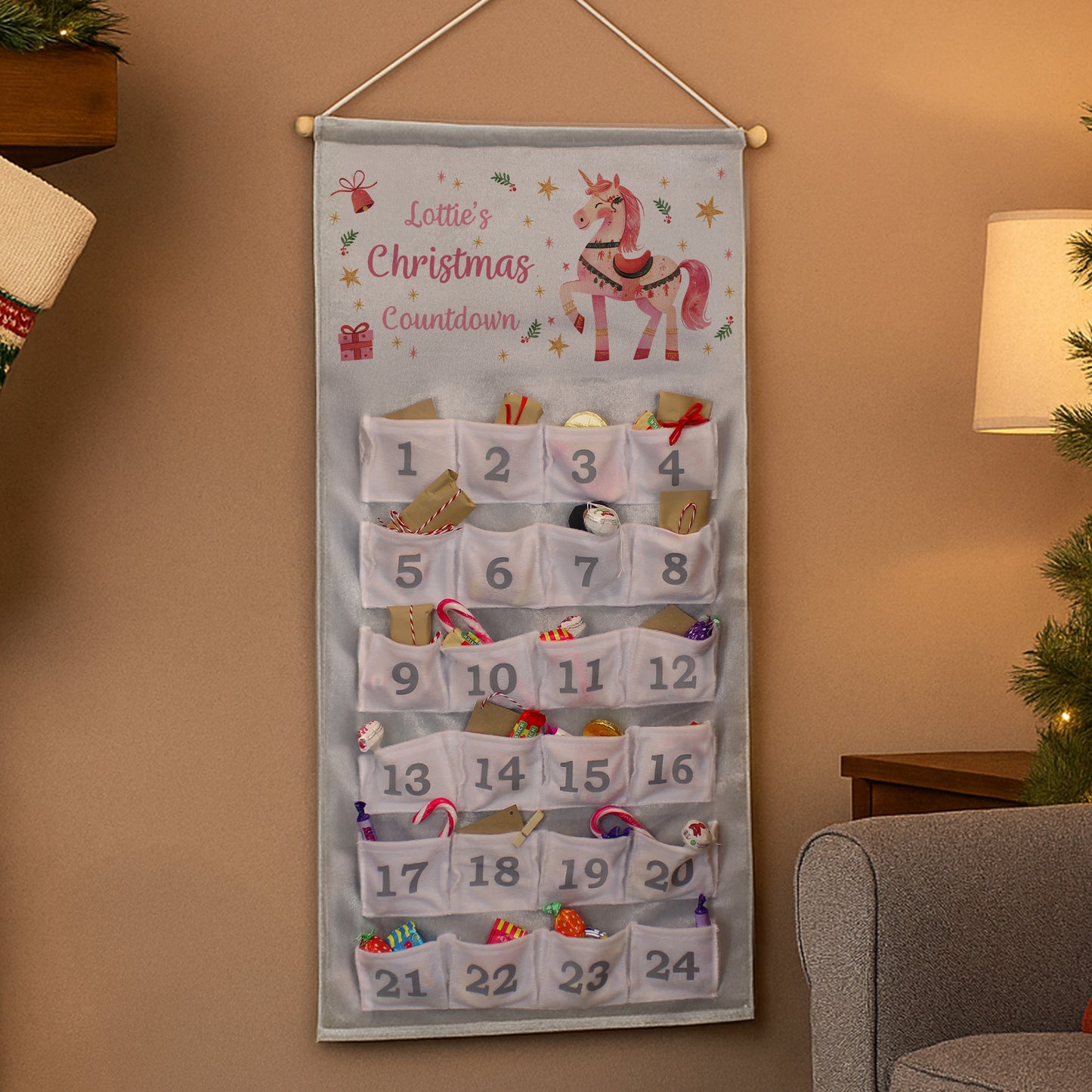 Christmas countdown calendar with a unicorn design on a wall.