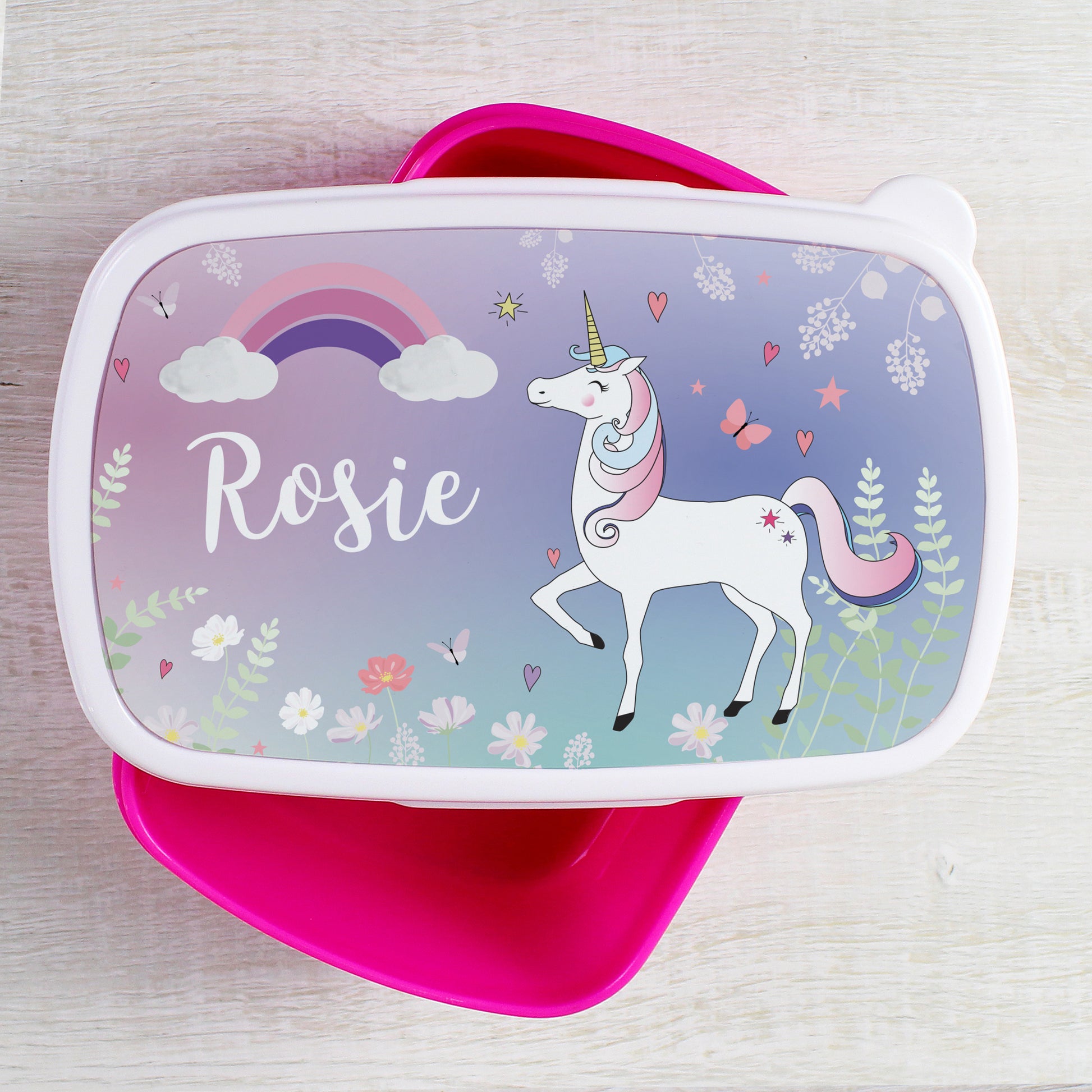 Lunch box with unicorn design and 'Rosie' on a light wooden surface