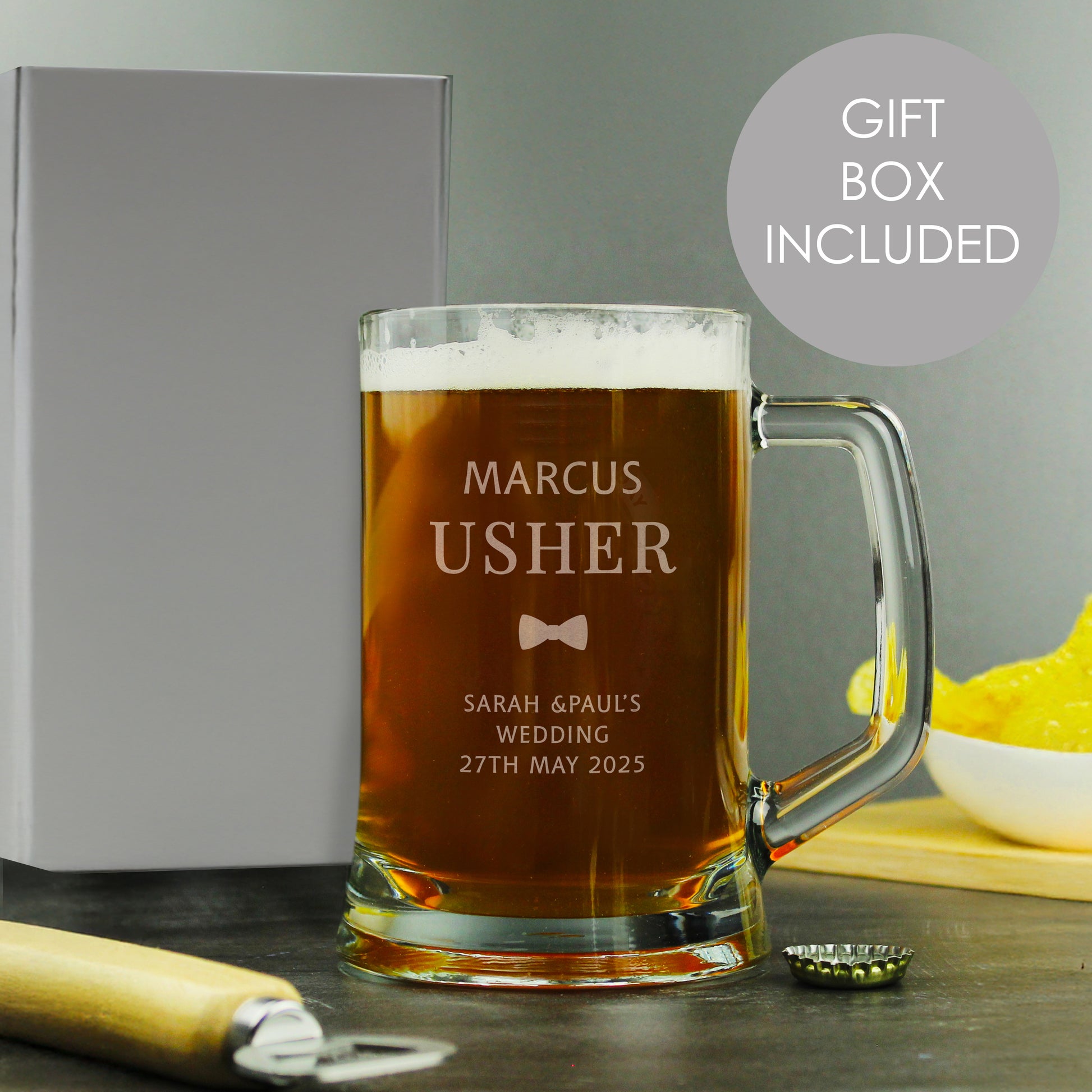 Personalised glass mug with beer, gift box, and bowl on a grey background.
