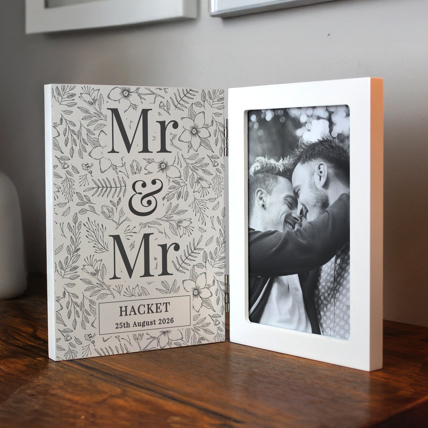 Personalised photo album with 'Mr & Mr' design and a black and white photo of two men on a wooden surface.