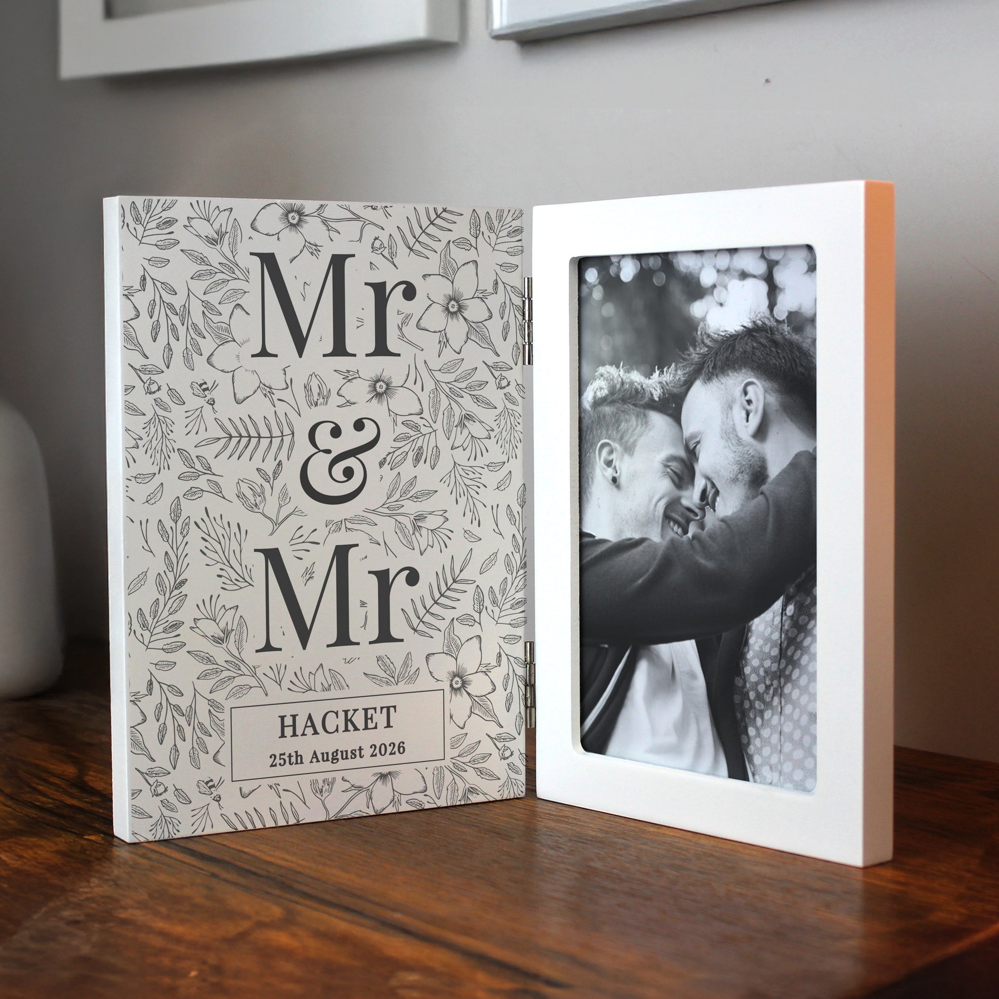 Personalised photo album with 'Mr & Mr' design and a black and white photo of two men on a wooden surface.
