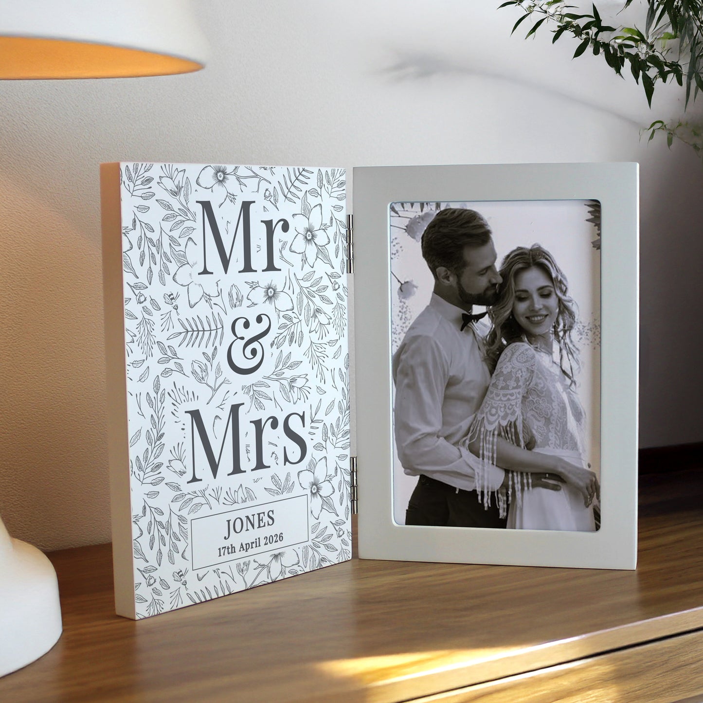 Personalised photo frame with 'Mr & Mrs' design and couple's photo on a wooden surface.