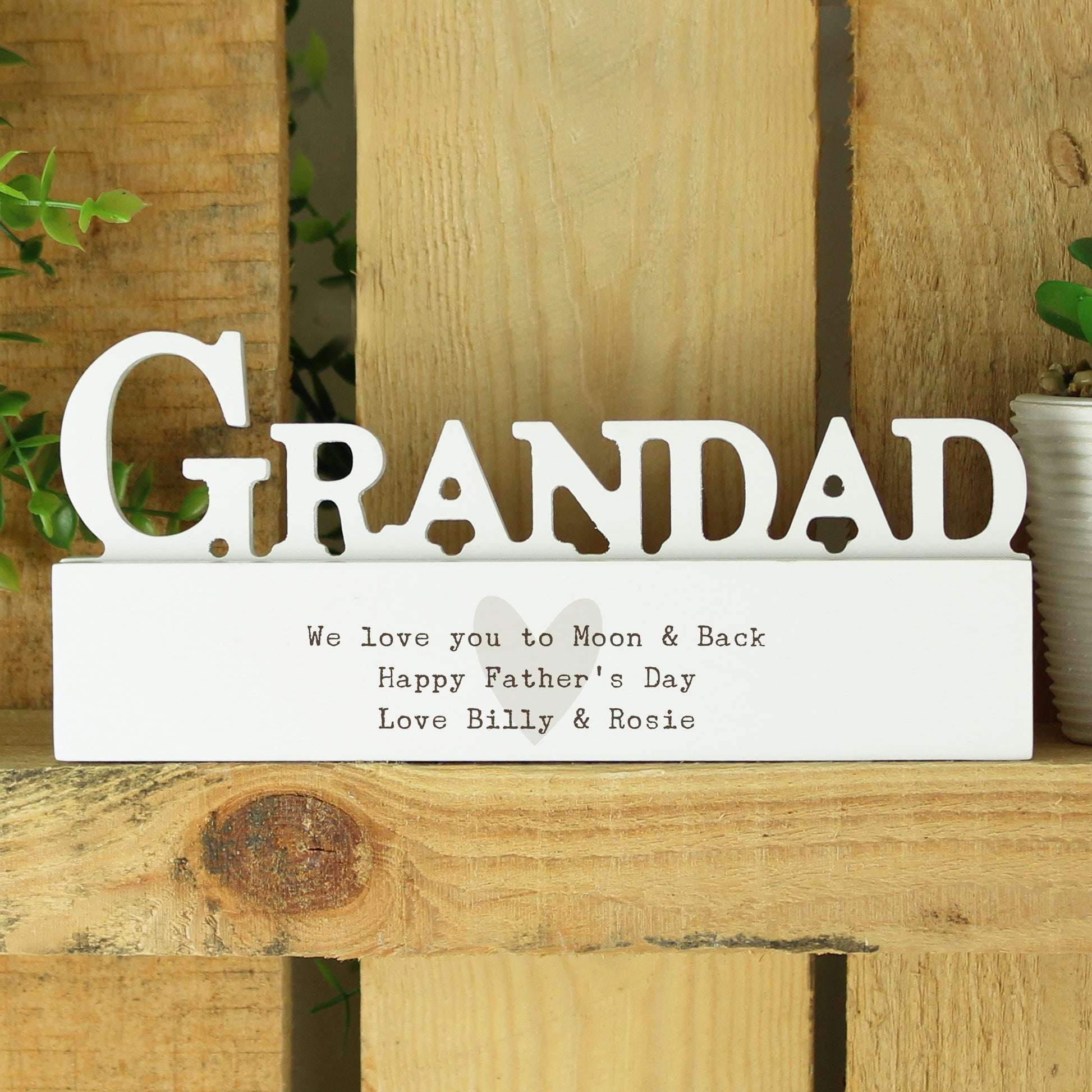 Wooden sign with 'GRANDAD' and a message on a wooden surface.