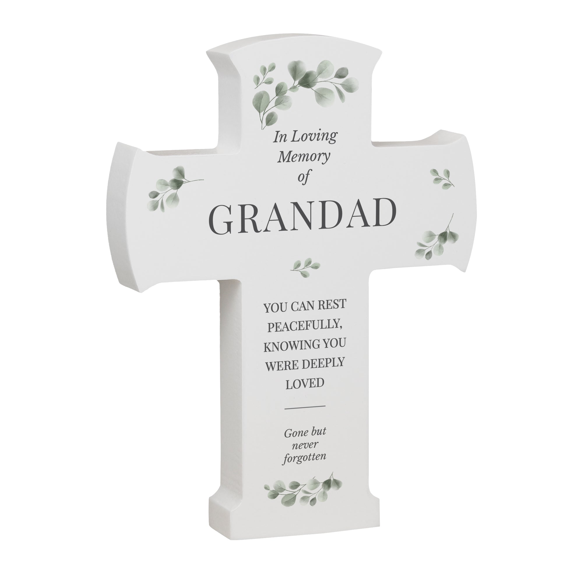 White cross-shaped memorial plaque with engraved text and greenery on a white background