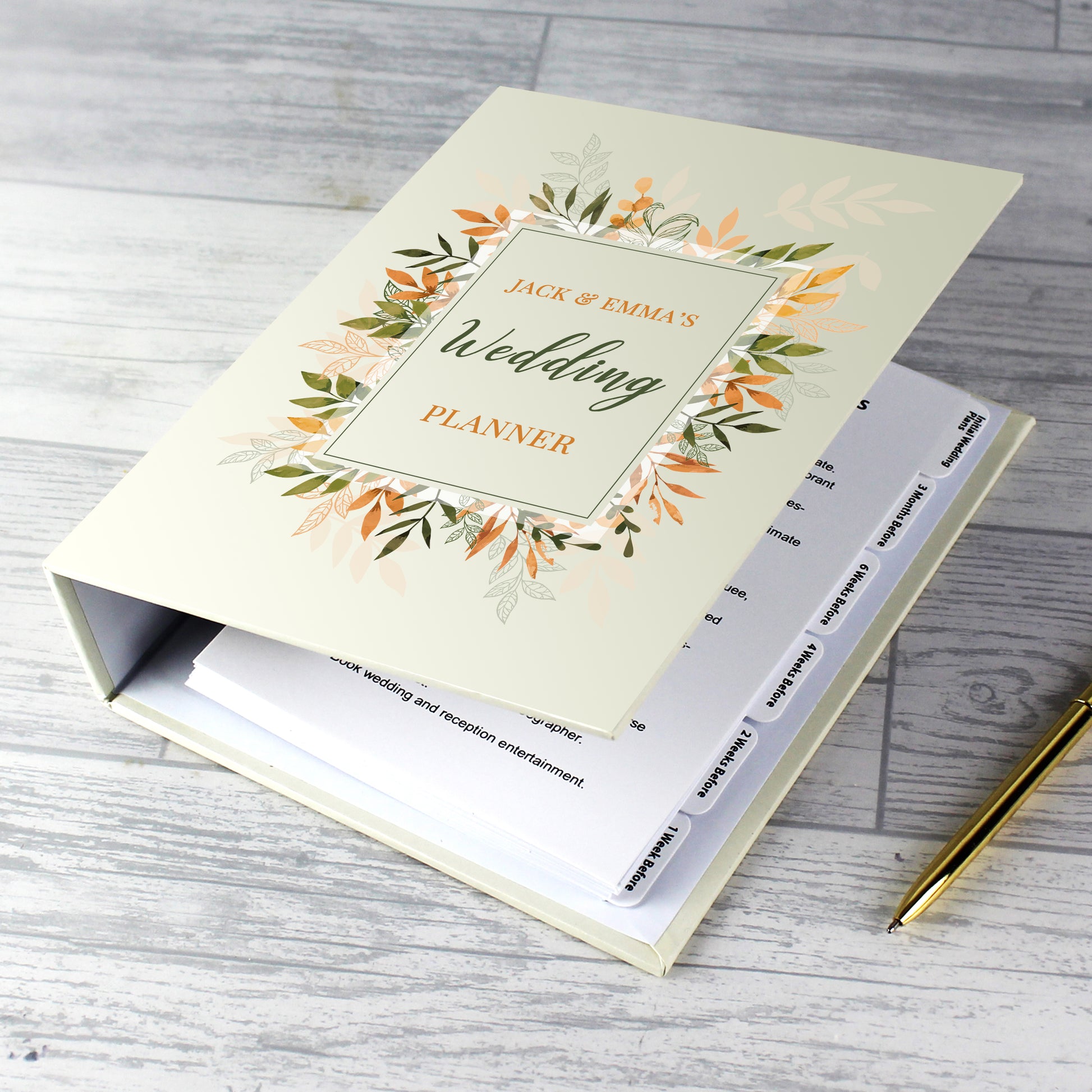 Wedding planner book with floral design on a wooden surface