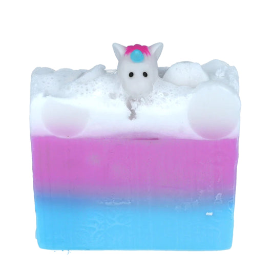Bomb Cosmetics Soap Slice - Unicorns and Rainbows in 3 stripes of colour. Blue lower stripe with pink in the middle and white on the top. A cute unicorn head at the top! It's a rainbow and unicorn kind of day, filled with Palmarosa and Rosemary essential oils . Glycerin soap. Vegan friendly.