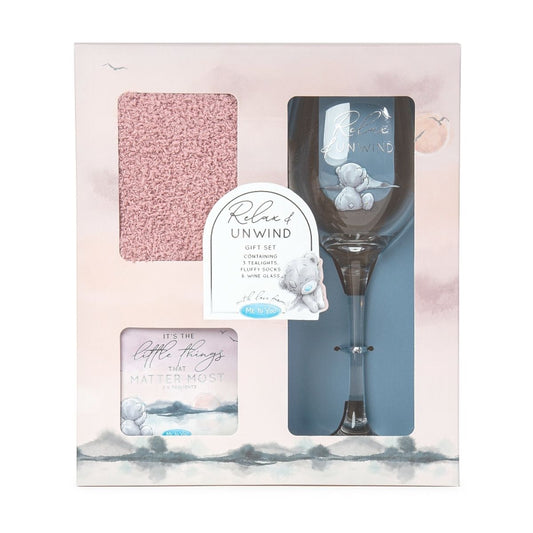 Me To You Classic Collection Relax & Unwind Gift Set featuring a stemmed Wine Glass, pink fluffy socks and 3 tealights in pretty box. Tealight box has text that reads - It's the little things that matter most. Wine Glass has text - Relax & Unwind. All in gift box.