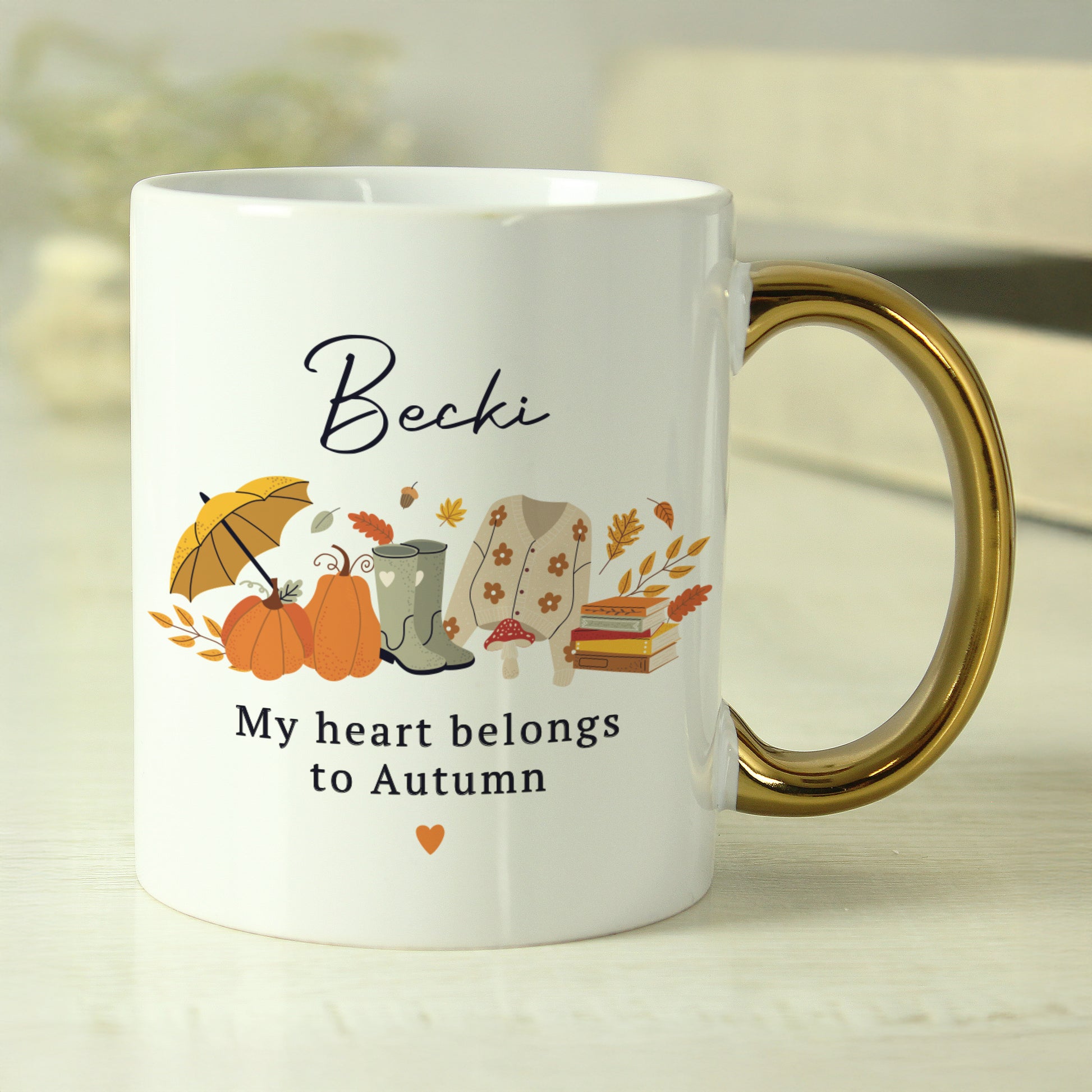 White mug with autumn-themed design and text on a light background