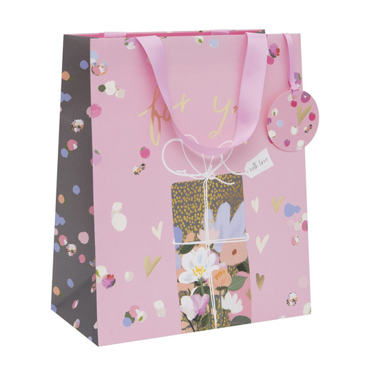 Large pink gift bag with floral present and gold foil text and hearts