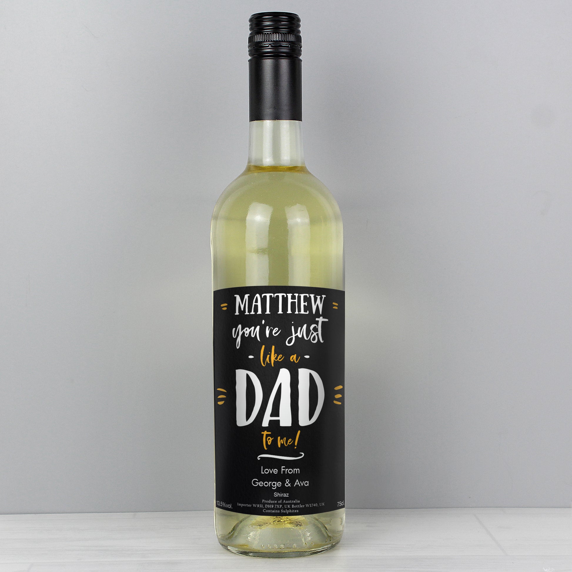 Wine bottle with a personalised label on a grey background