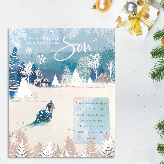 Blue & White theme card with man pulling christmas tree in the snow