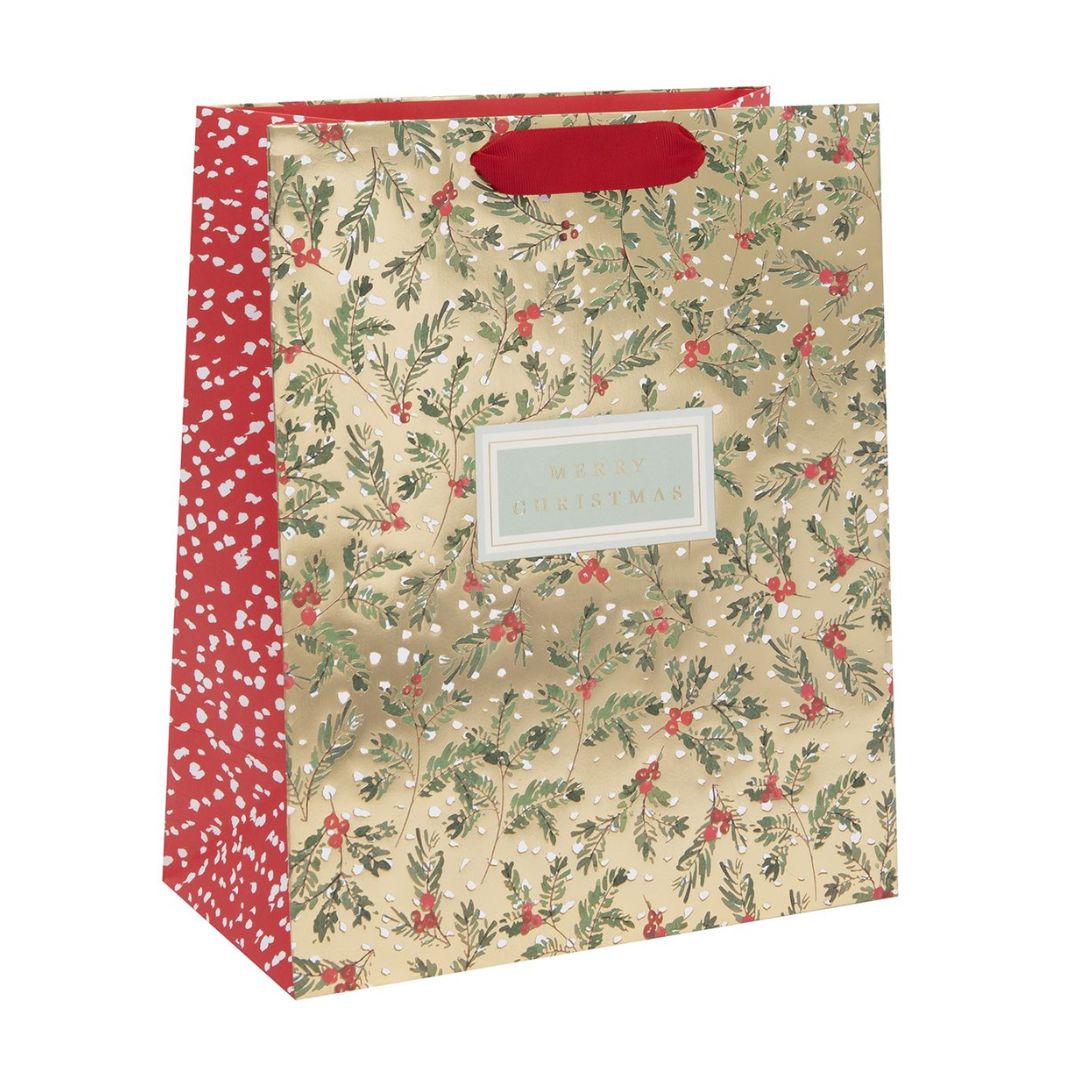 Gold bag with foliage and berries with Merry Christmas text and red ribbon handle