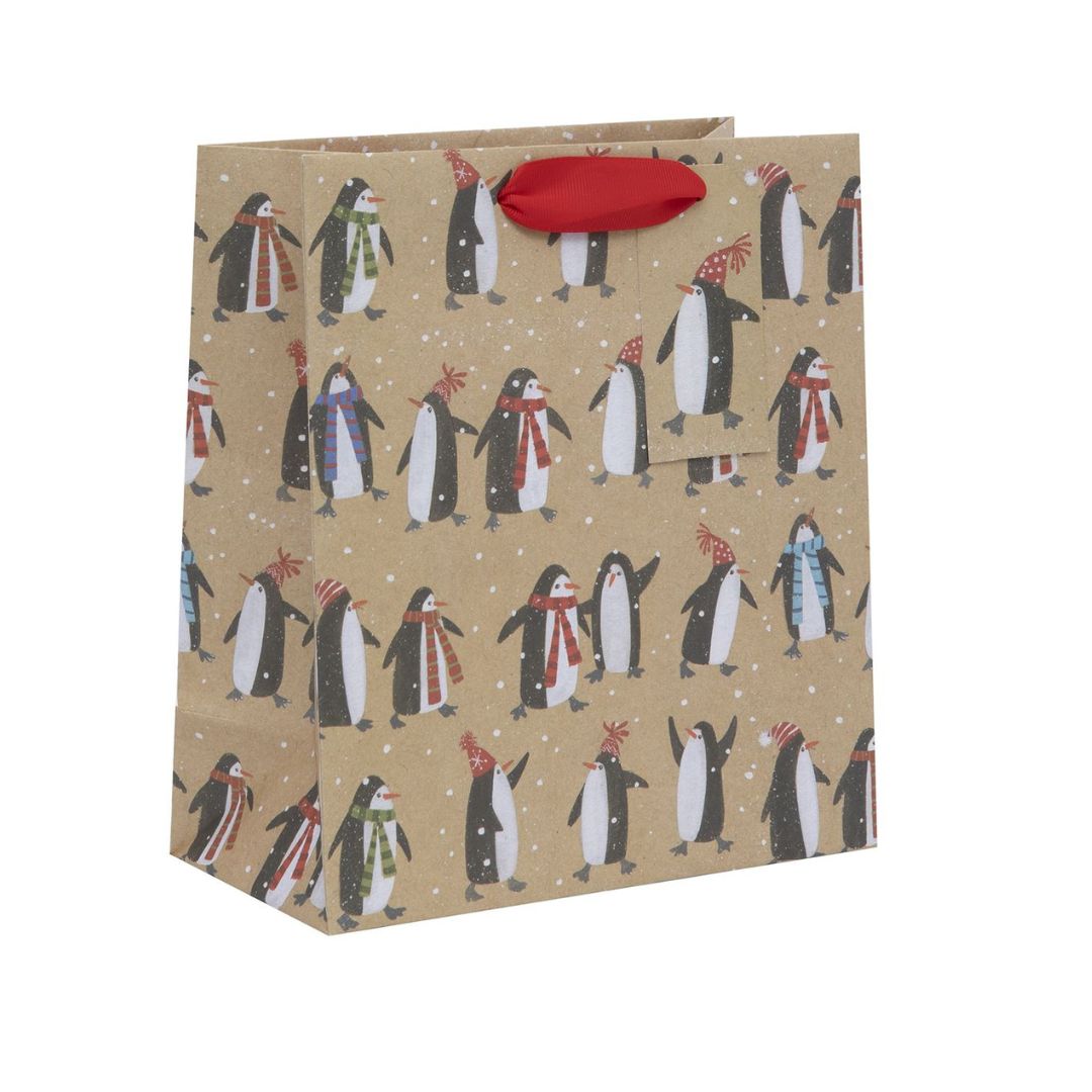 Kraft bag with penguins in scarves with snowfall. Red ribbon handles