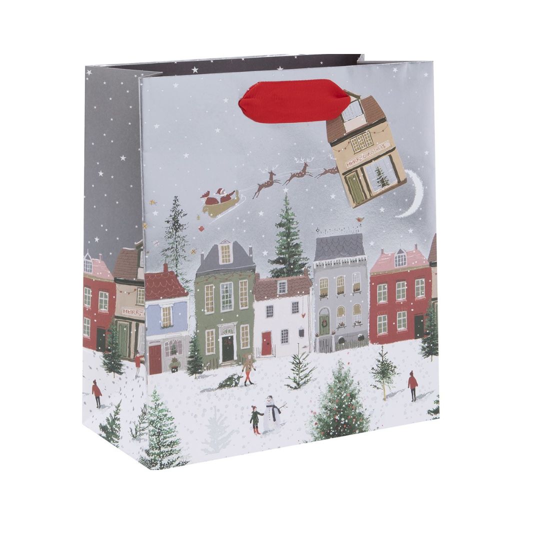 Silver gift bag with snow capped houses and santa's sleigh theme