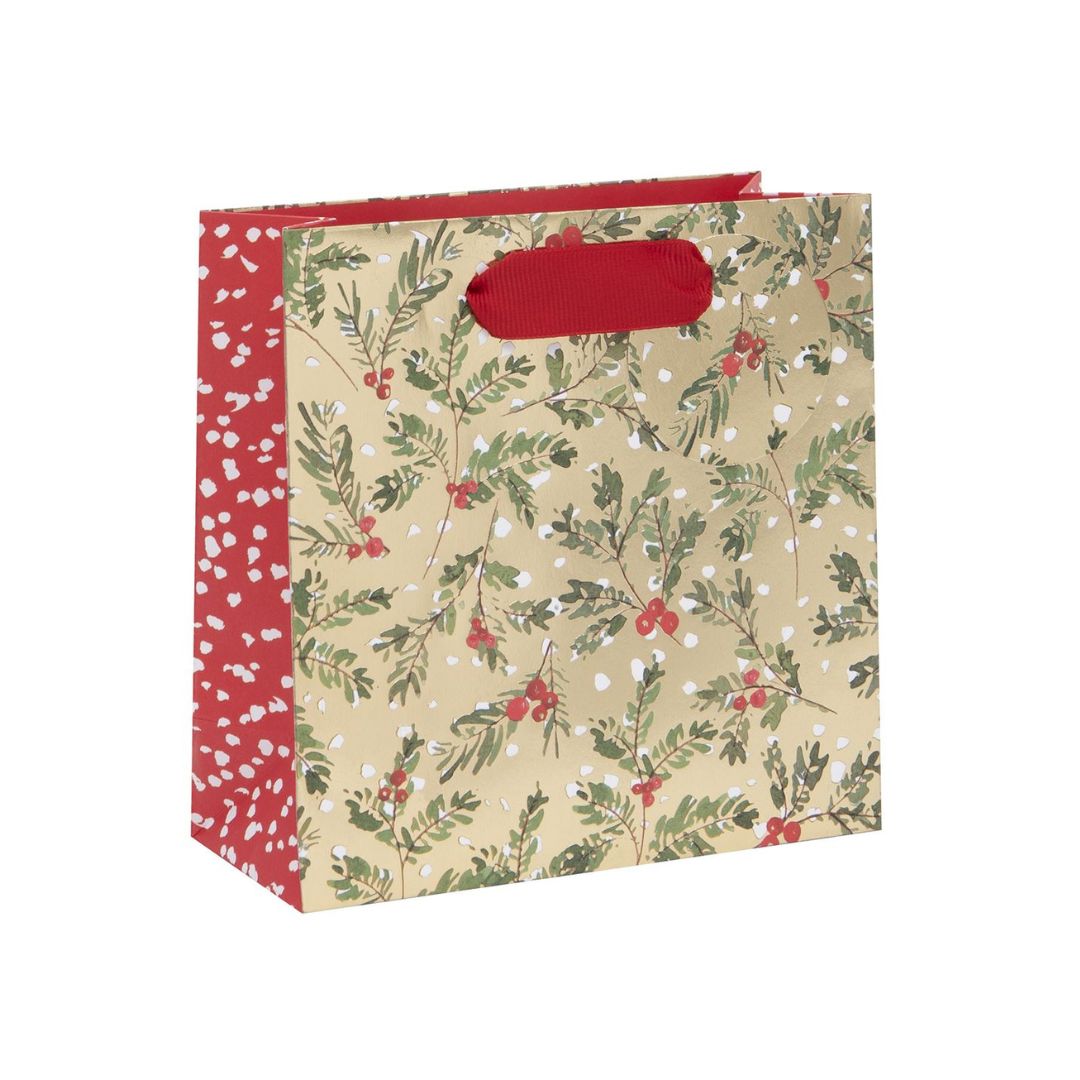 Gold bag with green foliage and red berries. With red ribbon handles and matching gift tag.