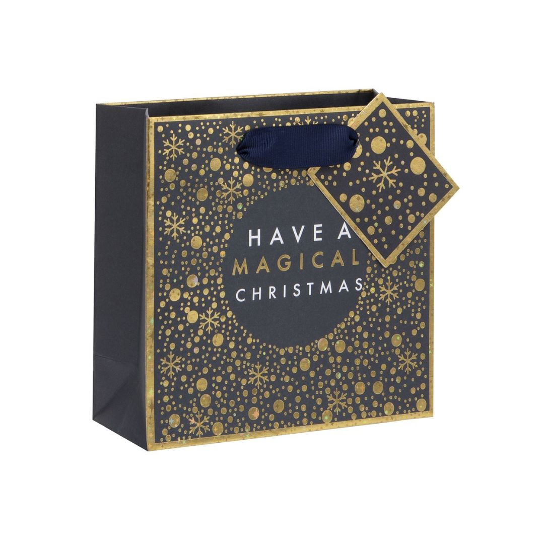 Black and gold bag with gold foil dots and snowflakes in astronical style