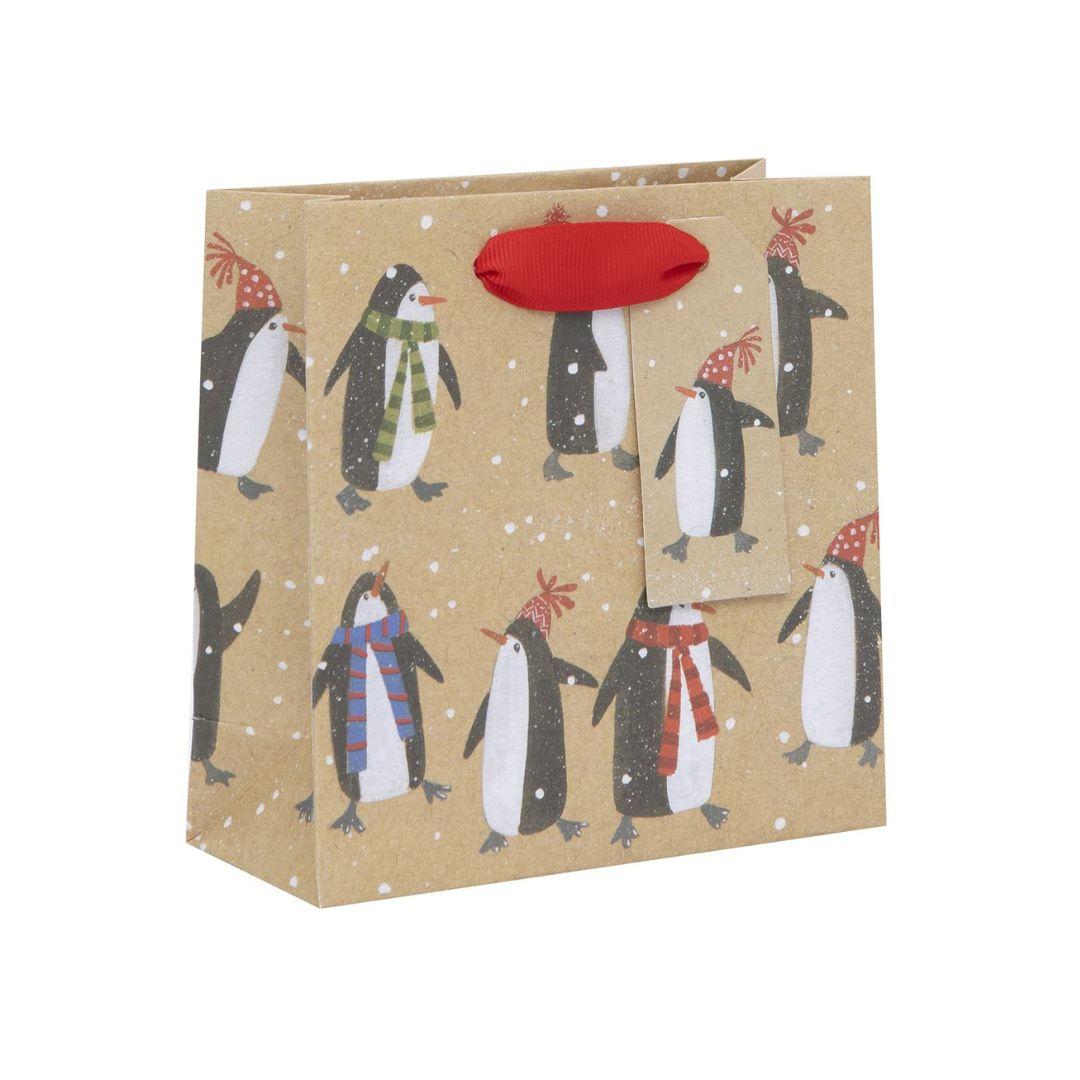 Kraft bag with penguins in scarves and red ribbon handle