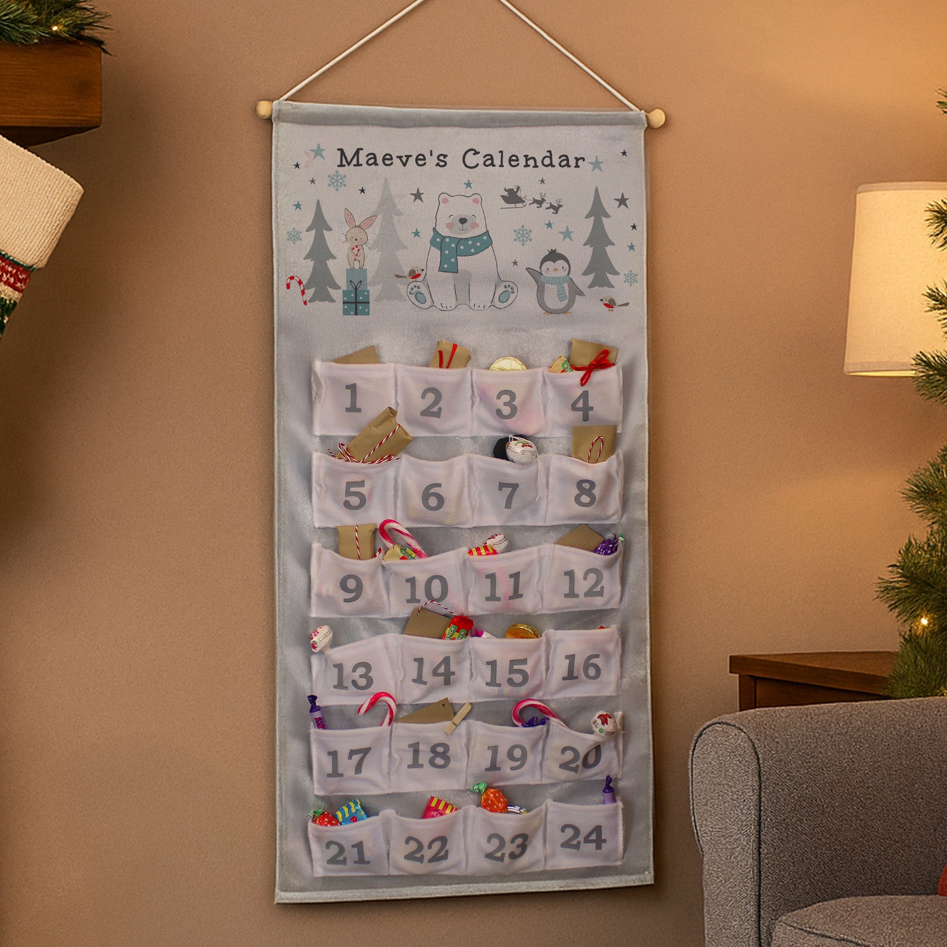Decorative Advent calendar with festive designs hanging on a wall.