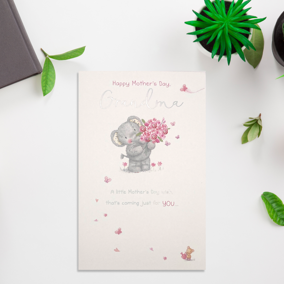 white card with grey elephant character with pink roses