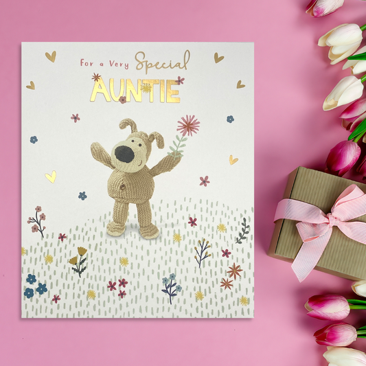 Square card with Boofle character among flowers with gold foil text