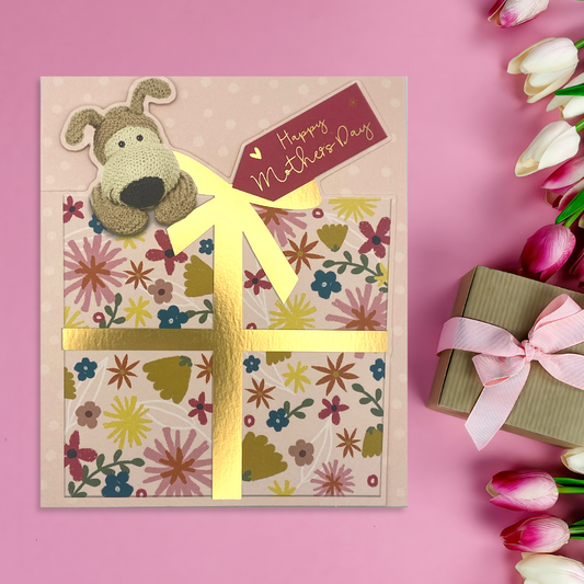 Boofle on floral gift with gold foil detail and pink tag