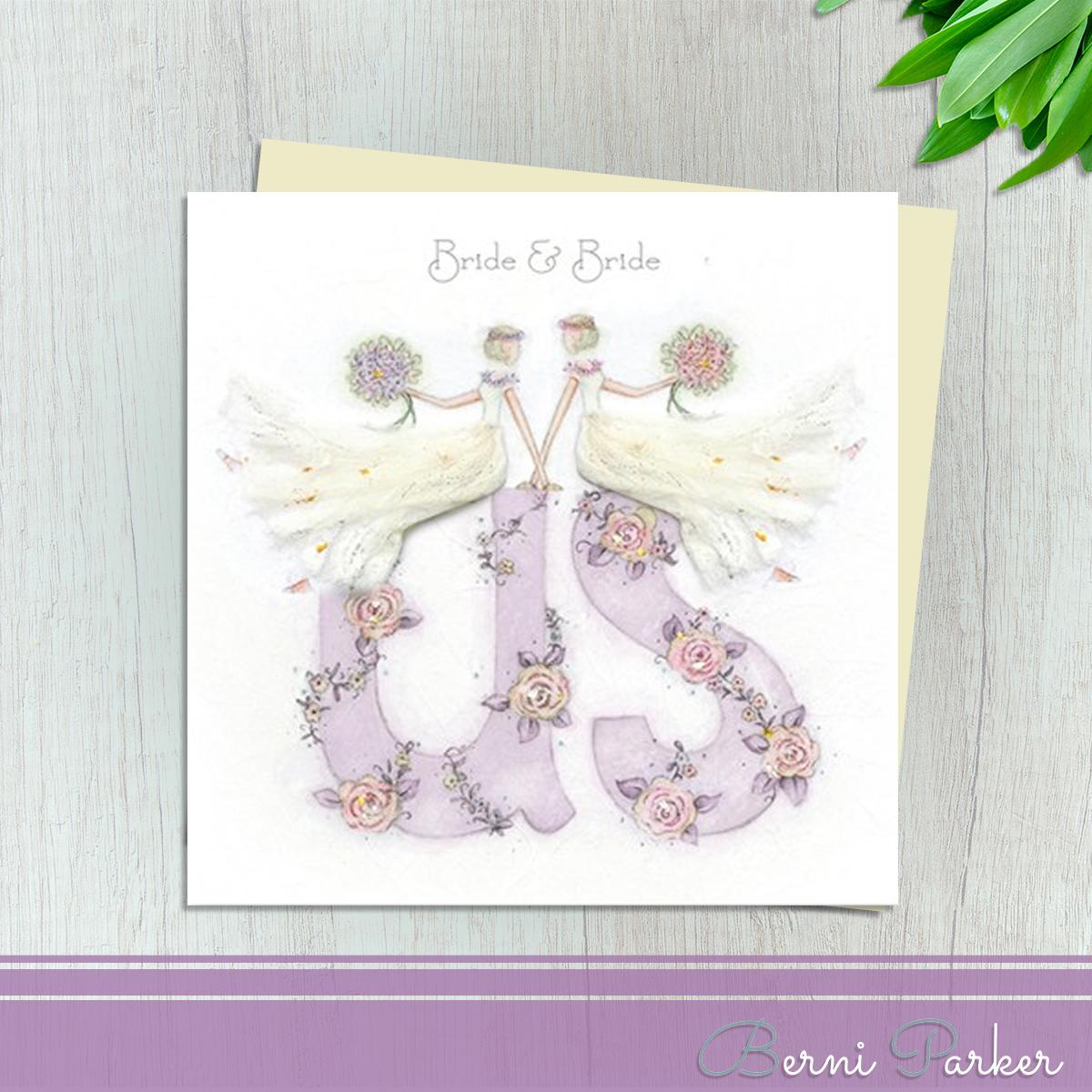 Two Brides Sitting On The Word Us For This Pretty Wedding Day Card From Berni Parker Designs. Finished With Silver Accents And Completed With An Ivory Envelope