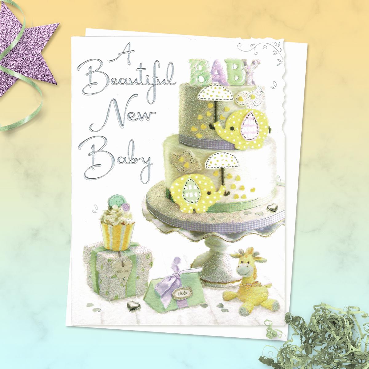 A Beautiful New Baby' Card Featuring A Two Tier Cake With Gifts And Soft Toy In Lemon And Pastel Green. With Added Sparkle And Silver Foil Detail. Complete With White Envelope