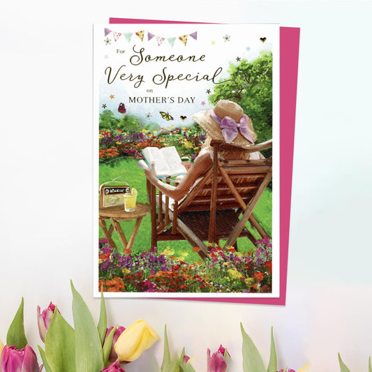For Someone Very Special On Mother's Day' Card Featuring A Lady Sitting In the Garden Reading. With Beautiful Gold Foil Detail And Cerise Envelope