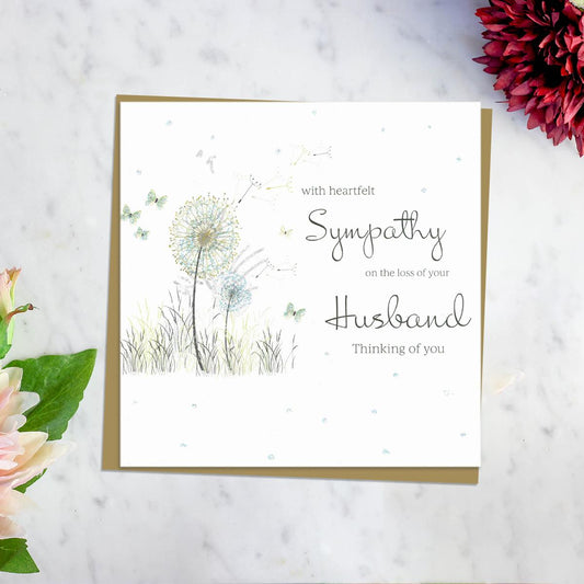 With Heartfelt Sympathy On The Loss Of Your Husband Thinking Of You' Card Featuring A Dandelion Blowing In The Wind With Surrounding Butterflies. Blank Inside For Own Message And Complete With Brown Envelope